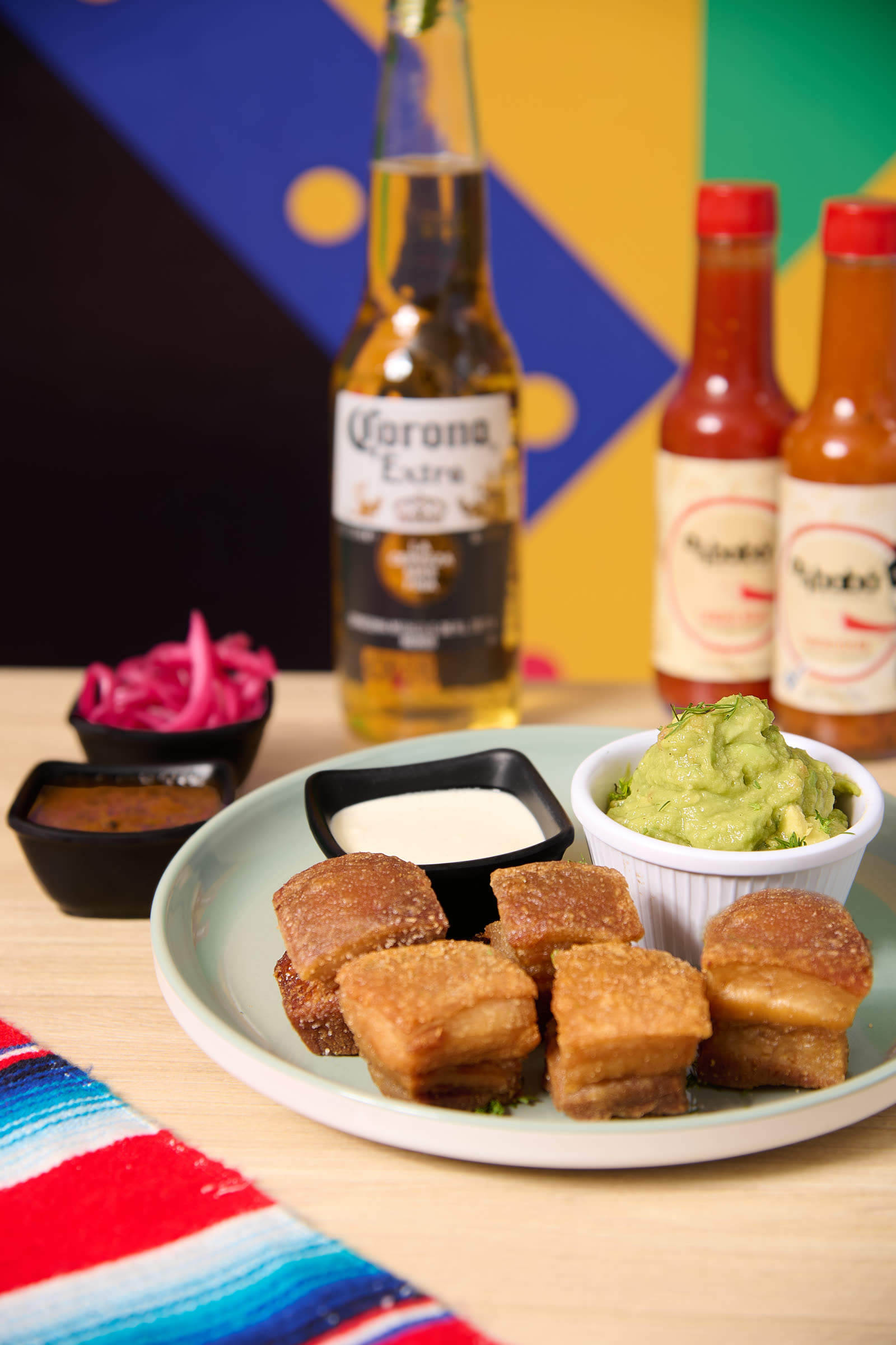 Chicharrones with Corona beer and salsas at Amor al Taco