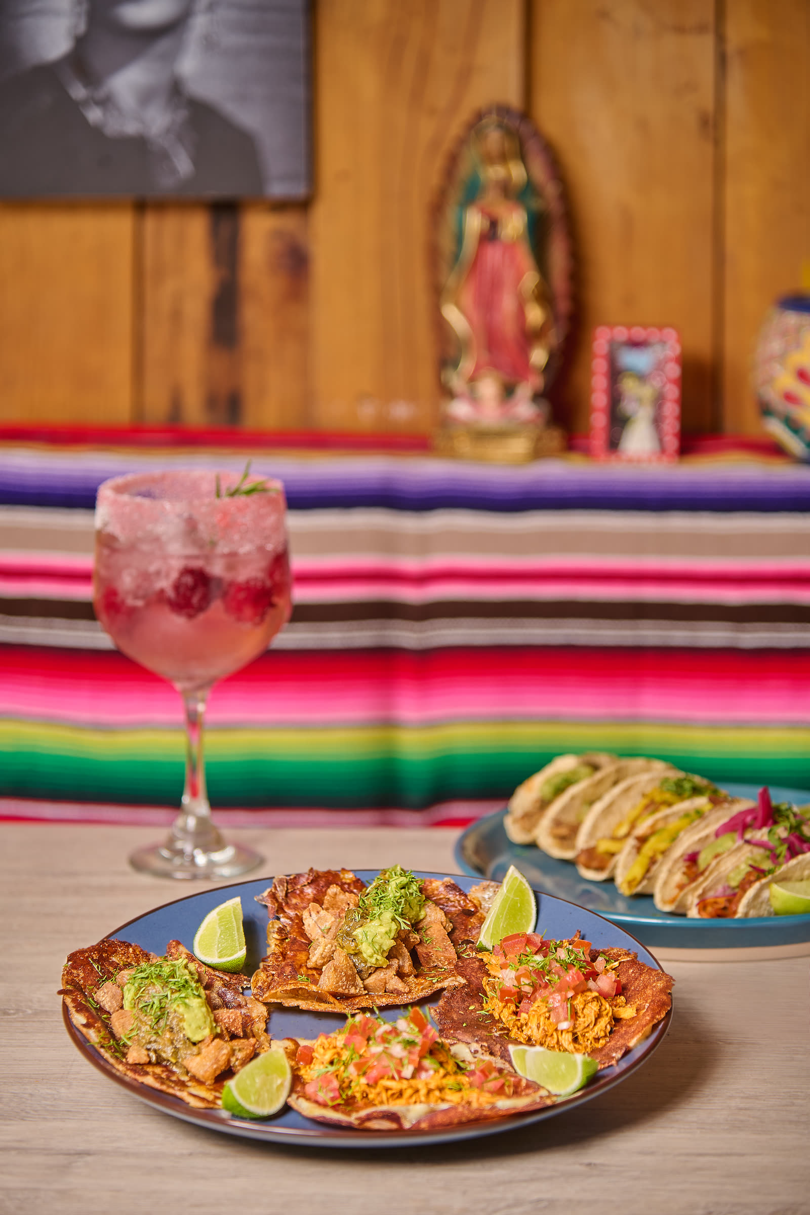 Interior of Amor al Taco in Bogotá with Virgin of Guadalupe and serape tablecloth